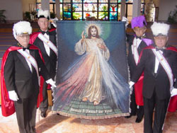 Knights of Columbus displaying the "DMP" Tapestry.